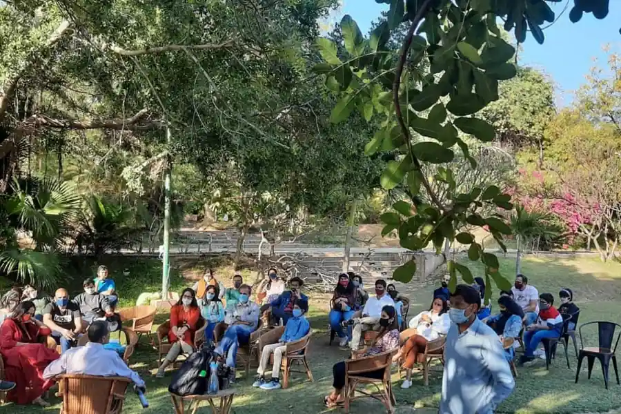A gathering on the lawn beneath the trees