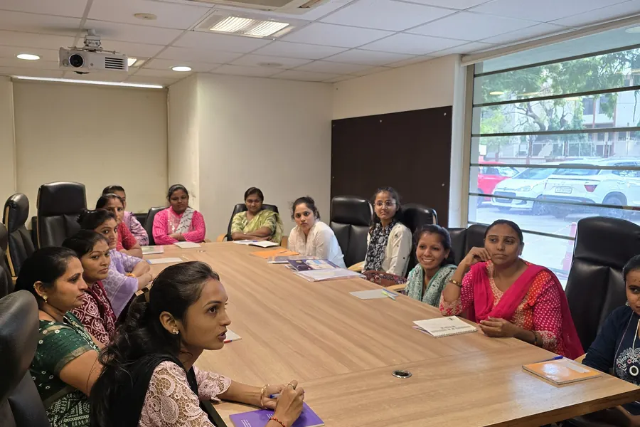 Women seated around the table at a capacity building session