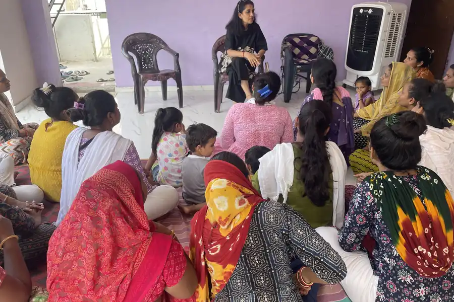 A community gathering of women seated together in a hall