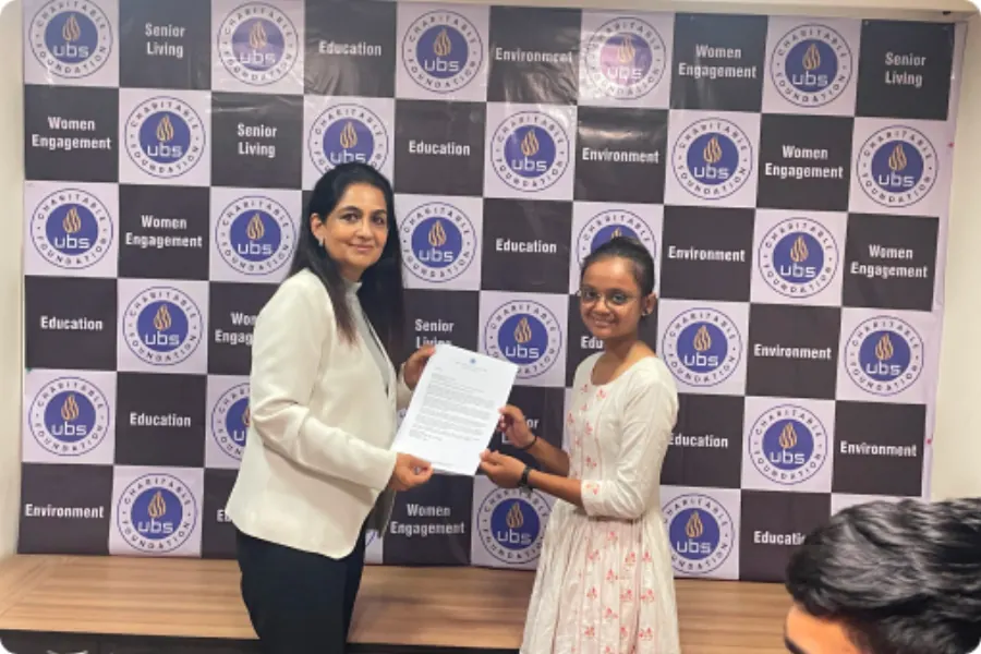 A scholar with her award letter after the ceremony