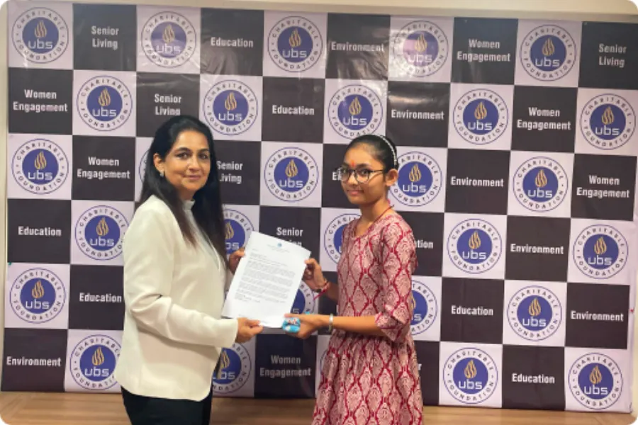 A student presented with her scholarship letter