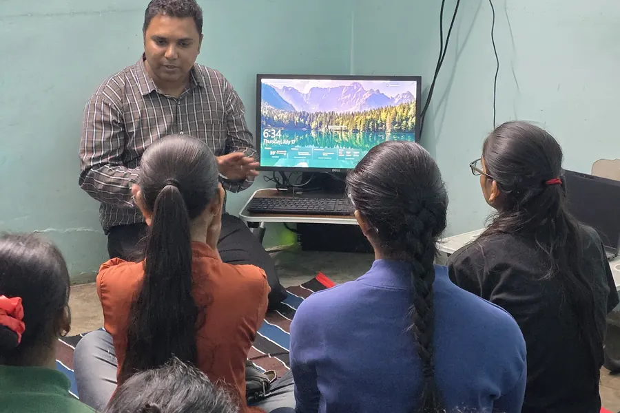 A lesson under way, students watching the screen at the front