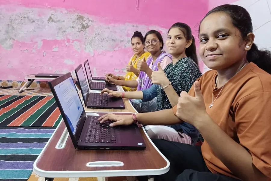 A student looking up from her laptop mid-lesson