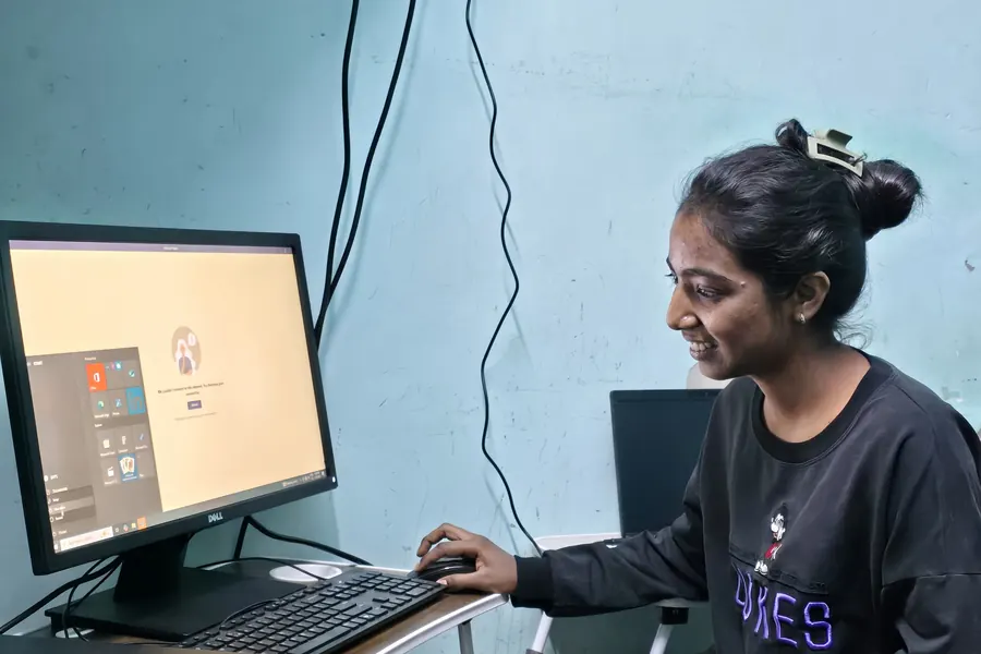 A student working alone at one of the desktop computers