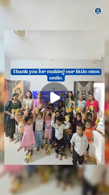 Children at a daycare centre with visitors from the Wheel Club